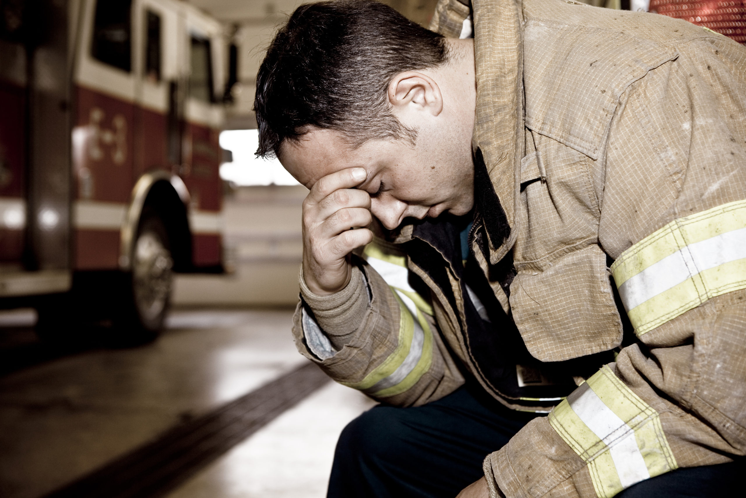 Exhausted firefighter bad news